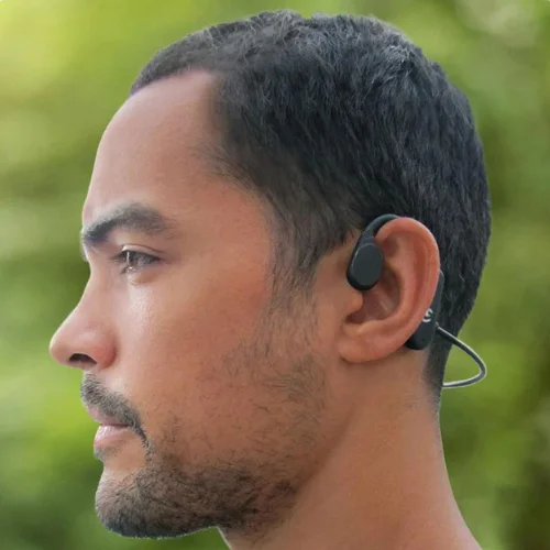 guy wearing Melody Buds in green background